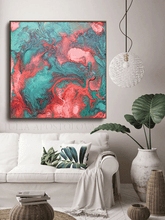 Living room with a colorful abstract painting, white sofa, and decorative plants.
