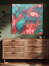Wooden dresser with a colorful coral green abstract painting above it on a dark wall.
