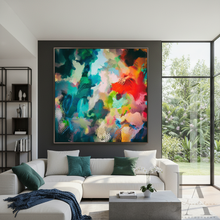 A large framed abstract canvas print with vibrant multicolor brushstrokes hangs on a dark gray wall above a modern white sectional sofa in a bright, contemporary living room.