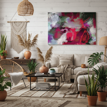 Living room with a colorful abstract painting, plants, and a beige sofa.