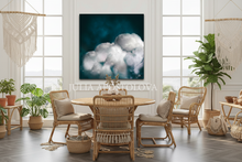 Dining room with dark teal cloud wall art, wicker chairs, round table, plants, and boho decorative elements.