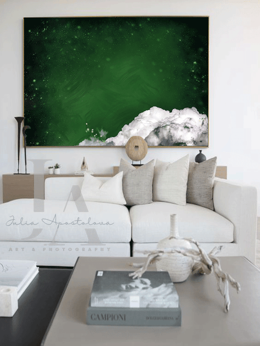 Boho living room with a large abstract minimalist cloud painting on the wall in shades of dark emerald green . The room features a white sectional sofa , a wooden coffee table , and a few decorative elements -a vase and a sculpture. The overall atmosphere is calm and serene.