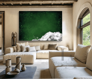 A modern living room featuring a large green minimalist painting on the wall. The painting future dark emerald green colors and a bit of fluffy white clouds in the one corner. The room has a light-colored sofa with cushions, a wooden coffee table with decorative bowls, and a minimalist decor style, creating a warm atmosphere.