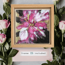 Framed abstract painting of a pink flower with roses and leaves in the background
