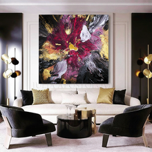 Modern living room with large floral abstract art, white sofa, and black chairs.