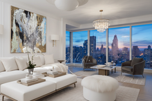 Modern living room with original gold leaf abstract painting by artist Julia Apostolova, modern white furniture, and city skyline view