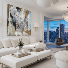 Modern living room with original gold leaf abstract painting by artist Julia Apostolova, modern white furniture, and city skyline view