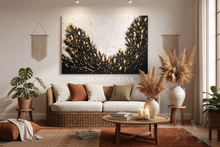 Living room with a couch, coffee table, decorative boho elements, like vases, candles, pillows, and a large abstract white black gold leaf painting on the wall, by artist Julia Apostolova.