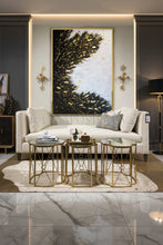Living room with a large black white gold leaf abstract painting by artist Julia Apostolova, white sofa, and decorative tables.