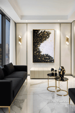 Modern living room with black sofa, marble floor, and abstract artwork. with black white gold colors and lots of gold leaf by artist Julia Apostolova.