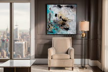 Modern living room with gold leaf abstract painting, armchair, and cityscape view