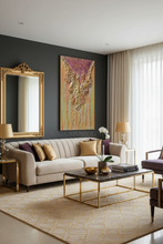 Modern living room with luxury gold sculpture painting by artist Julia Apostolova, a beige sofa, coffee table, and gold decorative elements.