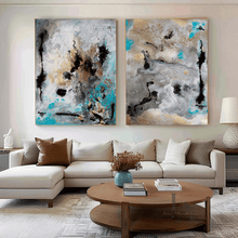 Living room with a beige sectional sofa, wooden coffee table, and abstract paintings on the wall.