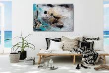 Living room with a white wall, abstract painting, sofa with pillows, and decorative items.