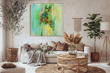A large framed abstract painting featuring vibrant green, yellow, and brown brushstrokes with a central multicolored figure, displayed on a textured beige wall above a sofa with decorative pillows.