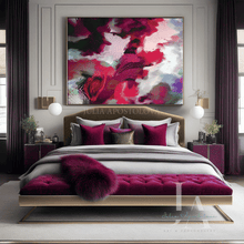 A luxury bedroom featuring a large abstract canvas painting with vibrant magenta, hot pink, and white brushstrokes hanging above a bed with matching magenta and gray bedding. The room is styled with deep purple curtains, gold-framed nightstands, and a tufted bench at the foot of the bed.