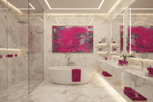 A luxury modern bathroom featuring a white freestanding bathtub, a glass shower enclosure, a long marble vanity with integrated lighting, and a large vibrant pink abstract wall art piece centered above the tub, by artist Julia Apostolova.