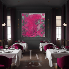 A large abstract wall art print with vibrant magenta, pink, and gray marbled patterns hangs on a dark gray wall in an elegant restaurant setting with white tablecloths, purple chairs, and deep purple drapes.