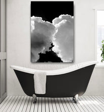 A modern bathroom with a large abstract cloud painting on the wall featuring kissing clouds in shades of white, and gray, against black sky. The bathroom includes black  white modern luxury bathtub, and white colors, creating a relaxing atmosphere.