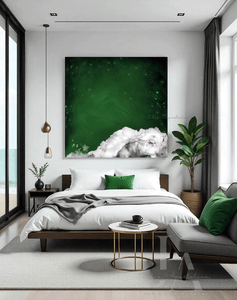A modern and minimalist bedroom with a large abstract cloud painting on the wall, featuring dark emerald green sky, white clouds and stars. The room has a cozy serene atmosphere, with a low platform bed, dark furniture, and natural elements like a tree branch. A large window overlooking a beach, a gray sofa, and a round gold coffee table Next to it, a sleek gold and chrome minimalist side table holds a coffee cup and a few stylishly arranged books, and there are tall plants in the corners.
