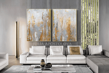 Modern living room with a gray sofa and abstract paintings on the wall.