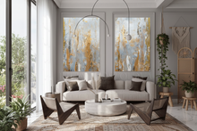 Modern living room with gray sofa, decorative elements, plants, and large neutral abstract wall art set with silver gray, and gold leaf, by artist Julia Apostolova.