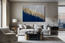 Modern living room with a large abstract painting on the wall with gold leaf, navy blue and silver/ gray colors, by artist Julia Apostolova