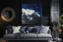 Living room with a gray sofa, decorative pillows, and a large cloud painting on the wall.