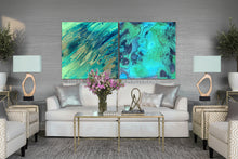 Living room with a gray sofa, teal blue ocean abstract art on the wall, and decorative items.