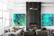 Modern living room with teal blue abstract paintings, a fireplace, and decorative items.