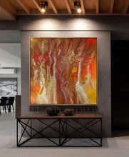 A large abstract copper gold painting with orange huge, hanging on the wall of a modern, minimalist office room with floor-to-ceiling windows.