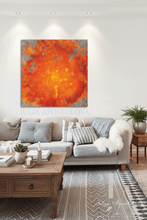 Living room with a large orange abstract painting on the wall, a sofa with cushions, and a coffee table.