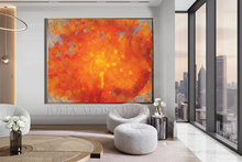 Modern living room with a large orange abstract painting, gray sofa, and cityscape view.