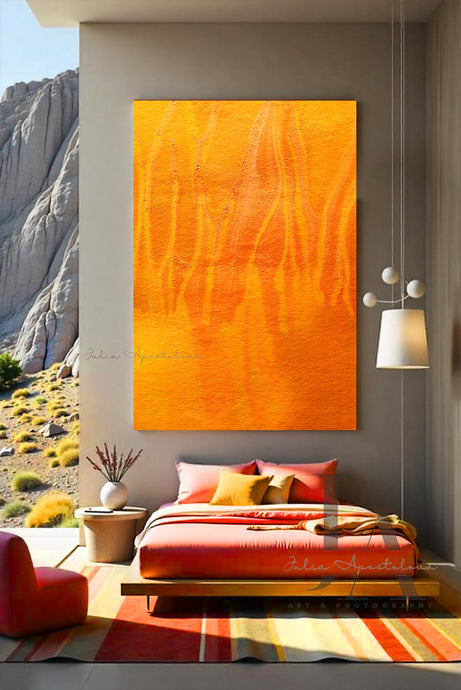 A modern and minimalist bedroom with a large yellow orange abstract painting on the wall , a bed with orange sheets and orange and yellow pillows . The room has a cozy serene atmosphere, with a low platform bed, orange poof and wooden furniture, and natural elements like a vases , lamps , and a large window overlooking a natural rocky landscape .