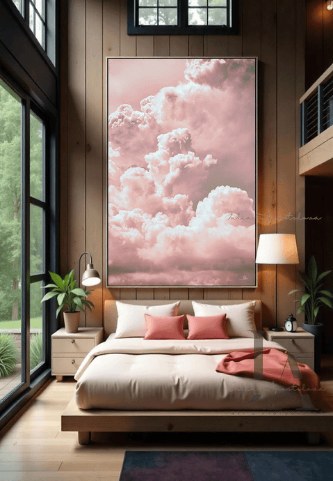 A large painting with blush pink clouds , displayed on the wall of a cozy bedroom with pink bedding sheets,  a large window overlooking a natural landscape. The room features a wooden bed frame and nightstand, creating a warm and inviting atmosphere
