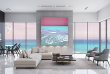 Modern living room with a large square ocean scene wall art, surrounded by large windows, with ocean view.