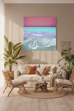 Living room with a large ocean painting on the wall, beige sofa, and wooden chairs.