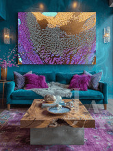Large abstract canvas wall art with purple, gold, and gold floral-like patterns, displayed above a teal sofa in a styled living room with purple pillows, a wooden coffee table, and a purple rug.