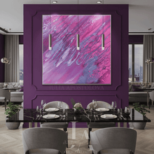 A large framed abstract painting with vibrant pink and purple brushstrokes hangs on a deep purple wall in a modern dining room setting with a black marble table and gray chairs.