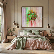 A framed abstract canvas painting by artist Julia Apostolova, with a colorful floral motif hangs on a beige wall above a bed in a modern, symmetrically styled bedroom. The painting features green, pink, red, and yellow brushstrokes with a green and red floral design in the center.