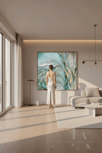 Woman in a white dress standing in a modern living room with a large sage teal abstract painting on the wall.