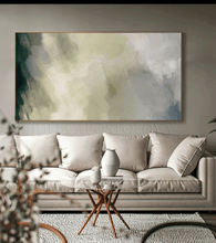Living room with a gray sofa, abstract sage green painting on the wall, and a small table.