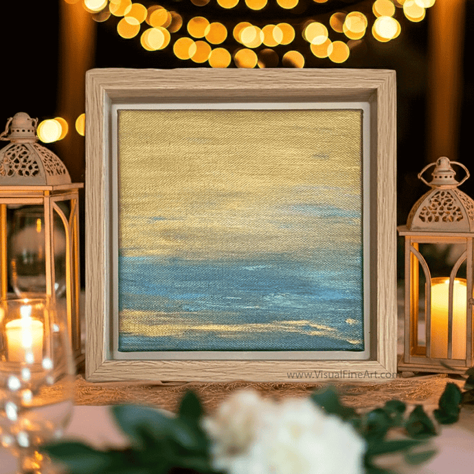 Framed abstract artwork with blurred lights and lanterns in the background
