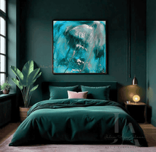 A modern bedroom featuring a dark green bed with matching bedding and a large square abstract wall art print in teal, turquoise, and silver tones, hung above the headboard on a dark green wall.