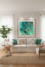 Living room with a beige sofa, decorative pillows, a plant, and a framed turquoise abstract painting on the wall.