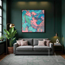 A square abstract wall art print with swirling pink, teal, and turquoise paint patterns, displayed in a modern living room setting above a gray sofa.