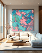 A large square abstract wall art print with swirling pink, teal, and turquoise fluid patterns hangs above a cream sectional sofa in a bright modern living room.