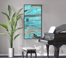 Abstract canvas wall art by Artist Julia Apostolova , featuring swirling turquoise, teal, black, gray, and orange marbled patterns, displayed in a black frame on a light gray wall in a styled room setting with a potted plant and a grand piano.