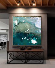 Large abstract wall art painting with swirling teal, aqua, white, and black marbled patterns, displayed in a modern interior above a console table.