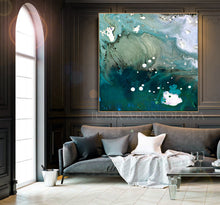 Large abstract canvas wall art with swirling teal, green, white, and blue marbled patterns, displayed above a gray sofa in a dark wood-paneled living room.